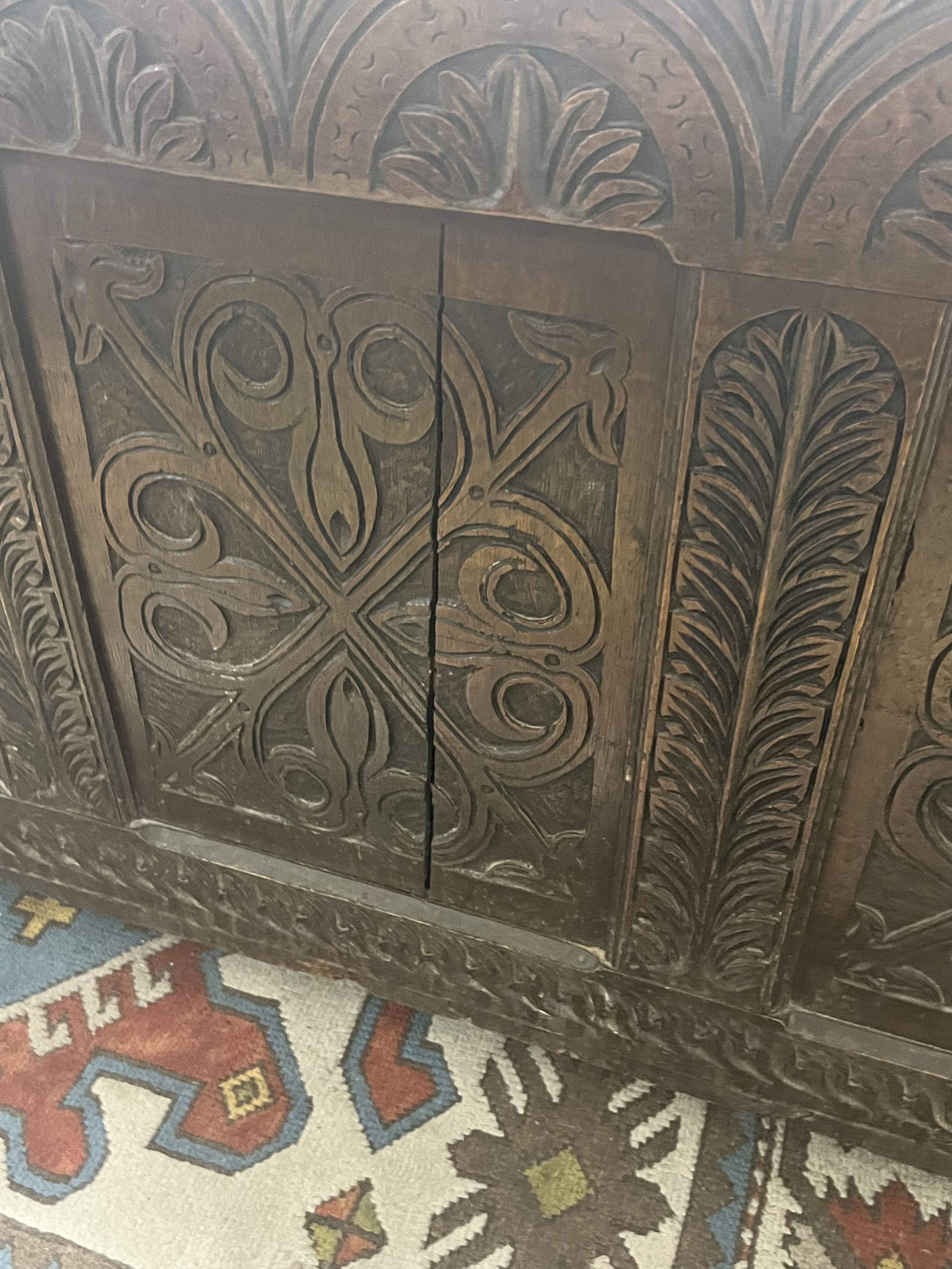 A large 18th century carved oak coffer, width 143cm depth 59cm height 77cm